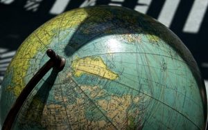 A detailed vintage globe showcasing northern regions with visible longitude and latitude lines.