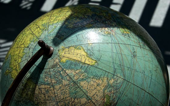 A detailed vintage globe showcasing northern regions with visible longitude and latitude lines.