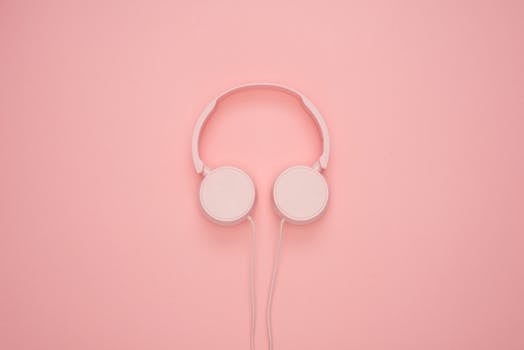 Aesthetic pink headphones on a pastel background, perfect for a modern and stylish look.