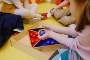 Kids enjoying playtime with educational wooden toys in a friendly environment.